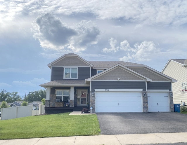 18916 Ivanhoe St NW, Elk River, MN 55330 - craftsman-style house featuring stone siding, driveway, a garage, and covered porch