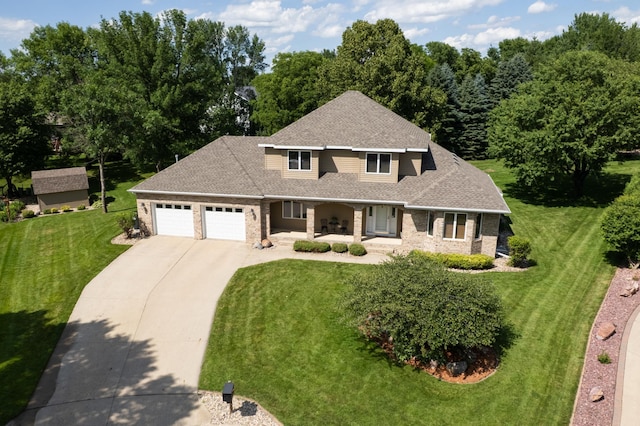 1201 Morningside Cir, Marshall, MN 56258 - traditional-style house featuring a porch, an attached garage, concrete driveway, a front yard, and a shingled roof