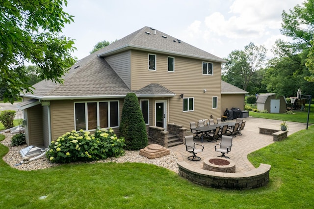 1201 Morningside Cir, Marshall, MN 56258 - back of property with a storage shed, an outdoor fire pit, a patio, and roof with shingles