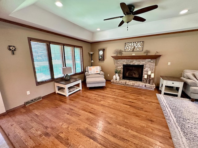 1201 Morningside Cir, Marshall, MN 56258 - living area featuring light wood finished floors, a raised ceiling, ceiling fan, recessed lighting, and a fireplace