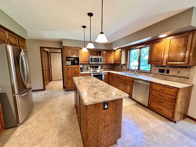 1201 Morningside Cir, Marshall, MN 56258 - kitchen featuring stainless steel appliances, light floors, a center island, brown cabinets, and a textured ceiling