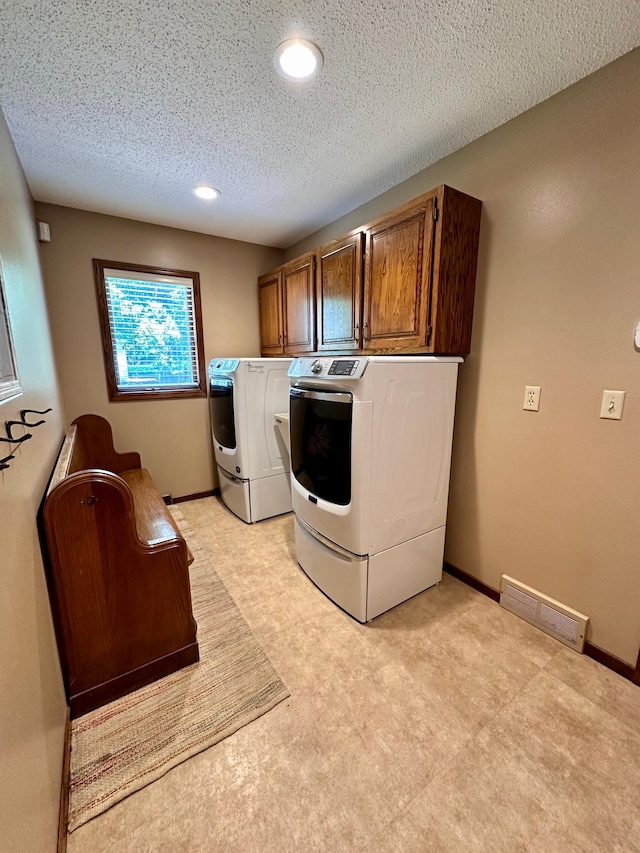1201 Morningside Cir, Marshall, MN 56258 - washroom featuring cabinet space, separate washer and dryer, a textured ceiling, recessed lighting, and light colored carpet