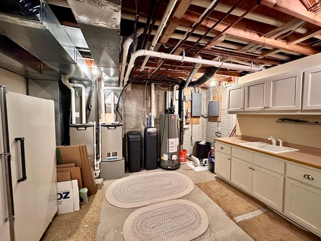 1201 Morningside Cir, Marshall, MN 56258 - unfinished basement featuring electric panel, water heater, brick wall, and freestanding refrigerator