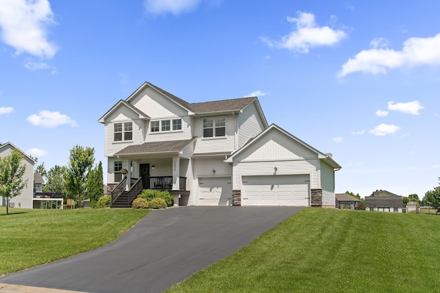 7850 242nd St, Wyoming, MN 55025 - view of front of property with driveway, stone siding, a front yard, covered porch, and an attached garage
