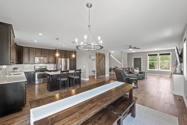 7850 242nd St, Wyoming, MN 55025 - dining room featuring a chandelier, ceiling fan, recessed lighting, and dark wood-style floors