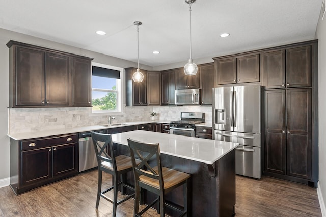 7850 242nd St, Wyoming, MN 55025 - kitchen featuring appliances with stainless steel finishes, dark brown cabinetry, dark wood-style flooring, and recessed lighting