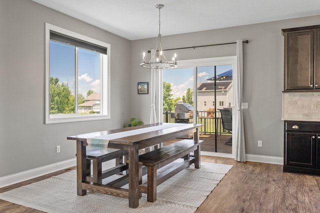 7850 242nd St, Wyoming, MN 55025 - dining space featuring a chandelier and wood finished floors