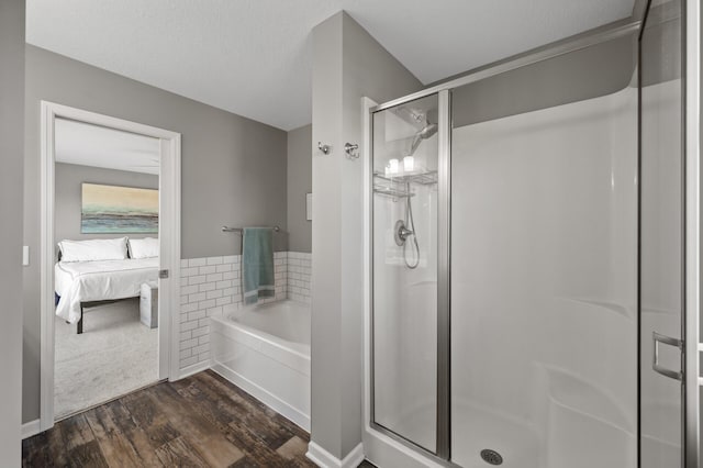 7850 242nd St, Wyoming, MN 55025 - ensuite bathroom with a shower stall, wood finished floors, and a bath
