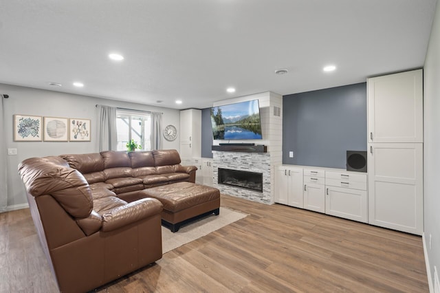7850 242nd St, Wyoming, MN 55025 - living room featuring a fireplace, light wood-style floors, and recessed lighting