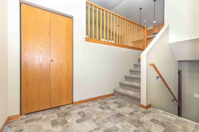 2054 12th St W, West Fargo, ND 58078 - staircase featuring stone finish floors and a towering ceiling