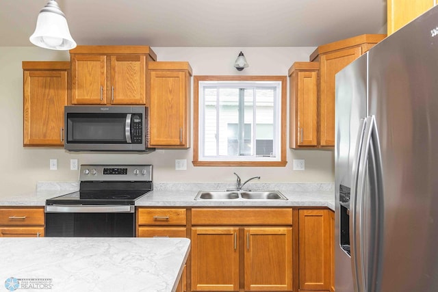 2054 12th St W, West Fargo, ND 58078 - kitchen with appliances with stainless steel finishes, light countertops, brown cabinets, and decorative light fixtures