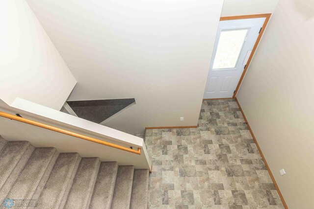 2054 12th St W, West Fargo, ND 58078 - stairway featuring baseboards and stone finish flooring