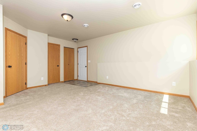 2054 12th St W, West Fargo, ND 58078 - unfurnished bedroom featuring multiple closets and carpet flooring