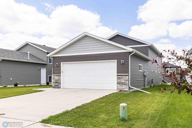 2054 12th St W, West Fargo, ND 58078 - view of front of house with stone siding, a garage, concrete driveway, and a front lawn