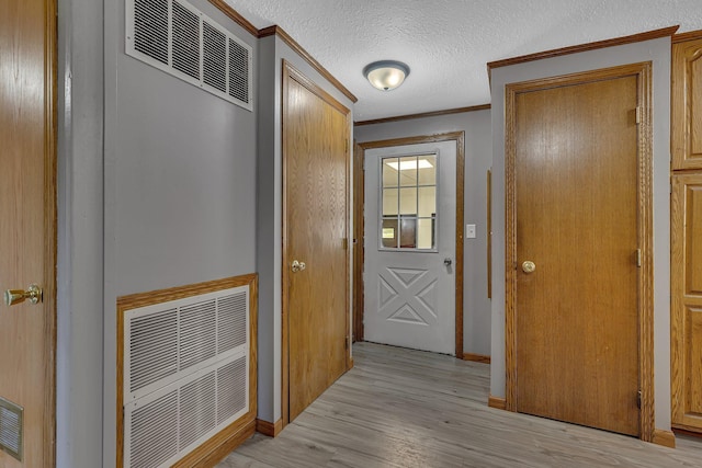 9353 Ideal Rd, Watab Twp, MN 56367 - doorway with crown molding, light wood finished floors, and a textured ceiling