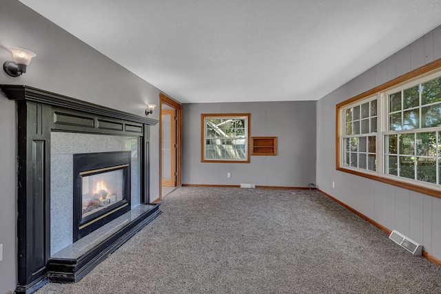 9353 Ideal Rd, Watab Twp, MN 56367 - unfurnished living room featuring carpet flooring and a glass covered fireplace