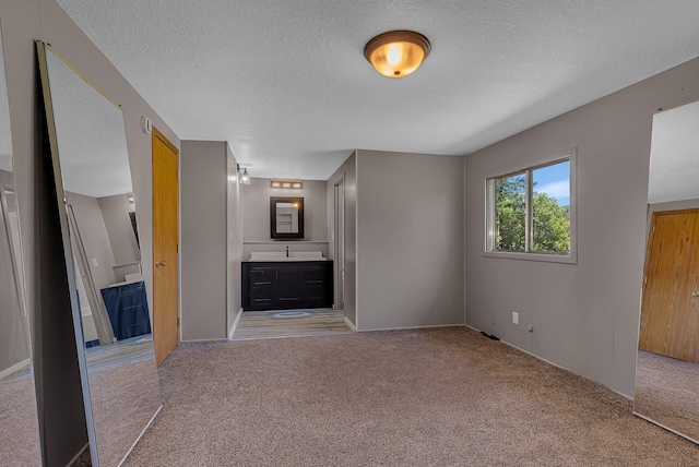 9353 Ideal Rd, Watab Twp, MN 56367 - unfurnished bedroom featuring carpet, a textured ceiling, and ensuite bathroom