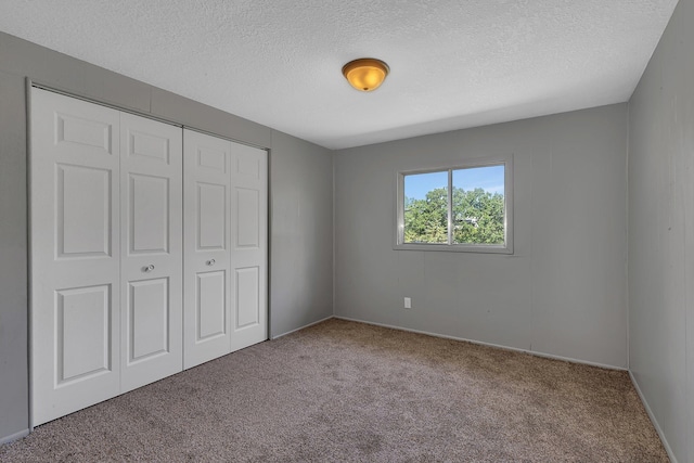9353 Ideal Rd, Watab Twp, MN 56367 - unfurnished bedroom featuring carpet flooring, a textured ceiling, and a closet