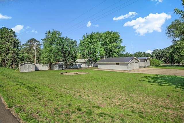 9353 Ideal Rd, Watab Twp, MN 56367 - view of yard with a shed, driveway, a detached garage, and view of wooded area