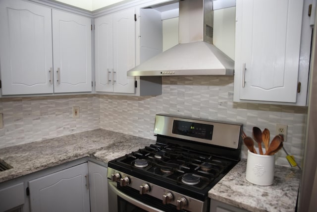 3930 99th Ave NE, Blaine, MN 55014 - kitchen featuring wall chimney exhaust hood, gas range, tasteful backsplash, and white cabinetry