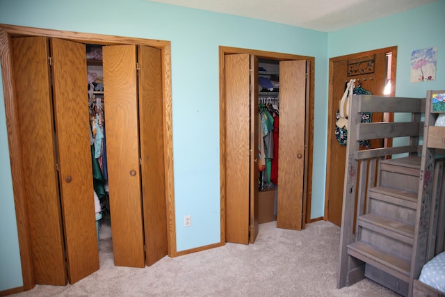 3930 99th Ave NE, Blaine, MN 55014 - bedroom featuring multiple closets and carpet flooring