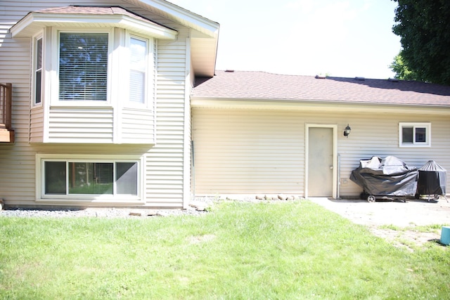 3930 99th Ave NE, Blaine, MN 55014 - back of house featuring a yard, a shingled roof, and a patio