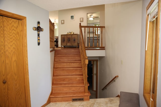 3930 99th Ave NE, Blaine, MN 55014 - staircase featuring ceiling fan and tile patterned flooring