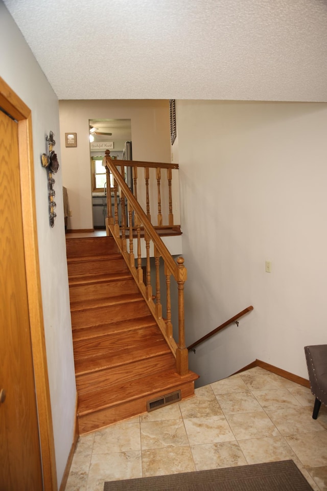 3930 99th Ave NE, Blaine, MN 55014 - staircase with a textured ceiling and a ceiling fan
