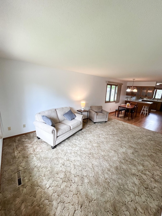 428 16th St, Windom, MN 56101 - carpeted living room featuring a textured ceiling and baseboards