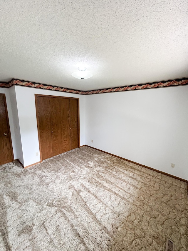 428 16th St, Windom, MN 56101 - unfurnished bedroom with carpet floors, a closet, and a textured ceiling