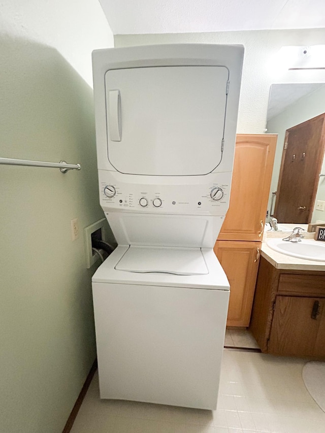 428 16th St, Windom, MN 56101 - washroom with stacked washing machine and dryer and light tile patterned flooring