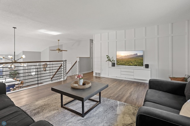 3501 19th St S, Fargo, ND 58104 - living room with wood finished floors, a chandelier, a ceiling fan, and lofted ceiling