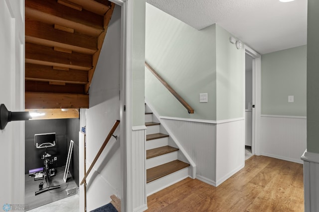 3501 19th St S, Fargo, ND 58104 - stairs featuring wainscoting, wood finished floors, and a textured ceiling