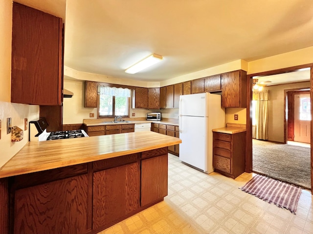 290 5th Ave, Granite Falls, MN 56241 - kitchen with white appliances, a peninsula, butcher block countertops, and light floors