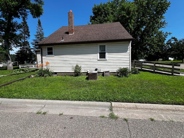 290 5th Ave, Granite Falls, MN 56241 - view of side of property featuring a chimney and a shingled roof