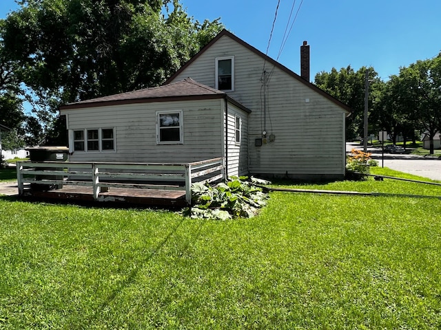 290 5th Ave, Granite Falls, MN 56241 - rear view of property with a chimney and a lawn