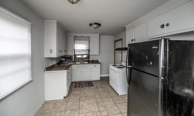 1194 Forest St, Saint Paul, MN 55106 - kitchen with freestanding refrigerator, electric range, white cabinets, and dark countertops