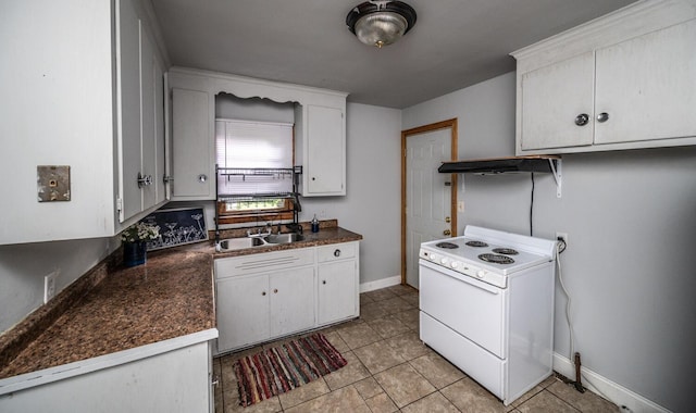 1194 Forest St, Saint Paul, MN 55106 - kitchen with white range with electric stovetop, dark countertops, white cabinetry, and light tile patterned floors