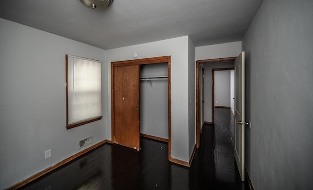 1194 Forest St, Saint Paul, MN 55106 - unfurnished bedroom with a closet and dark wood-style flooring