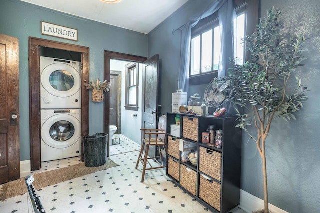 27960 County Highway 88, Carlisle Twp, MN 56537 - laundry area with stacked washer / drying machine and tile patterned floors
