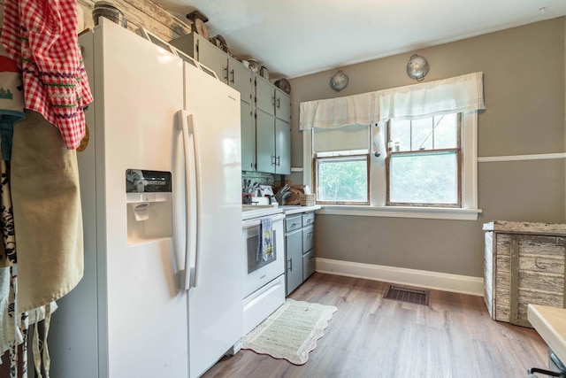 27960 County Highway 88, Carlisle Twp, MN 56537 - kitchen featuring white appliances, light wood finished floors, and light countertops