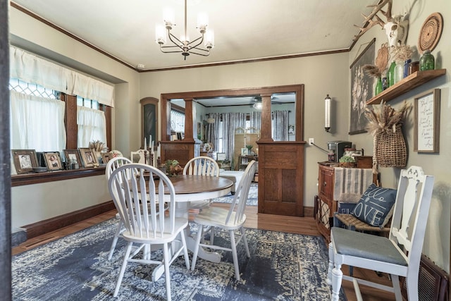 27960 County Highway 88, Carlisle Twp, MN 56537 - dining space with wood finished floors, a chandelier, and crown molding