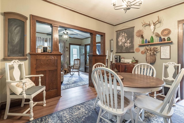 27960 County Highway 88, Carlisle Twp, MN 56537 - dining room featuring wood finished floors, ornate columns, crown molding, and a chandelier