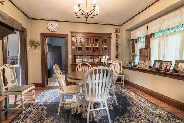 27960 County Highway 88, Carlisle Twp, MN 56537 - dining room with a chandelier, wood finished floors, and crown molding