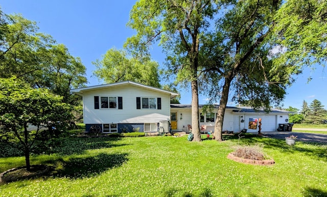 18467 County Road 21, Glenwood Twp, MN 56334 - tri-level home featuring asphalt driveway, an attached garage, and a front yard