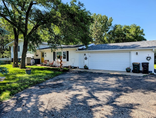 18467 County Road 21, Glenwood Twp, MN 56334 - tri-level home featuring driveway, an attached garage, and a front yard