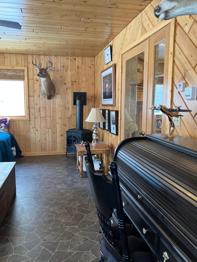 2040 Summit Dr, Cushing, MN 56443 - bedroom with stone flooring, wood walls, wood ceiling, and a wood stove