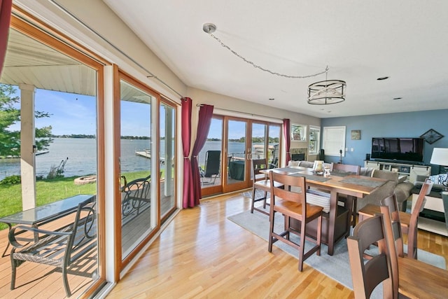 4936 210th St N, Forest Lake, MN 55025 - dining area with light wood-style floors, a water view, recessed lighting, and a chandelier