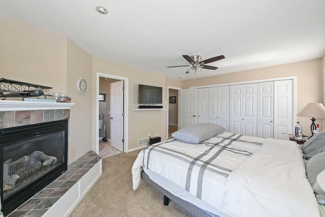 4936 210th St N, Forest Lake, MN 55025 - bedroom featuring carpet floors, a tiled fireplace, a closet, and ceiling fan