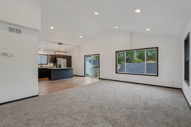 1002 Conway St, Saint Paul, MN 55106 - unfurnished living room featuring light carpet, recessed lighting, and high vaulted ceiling
